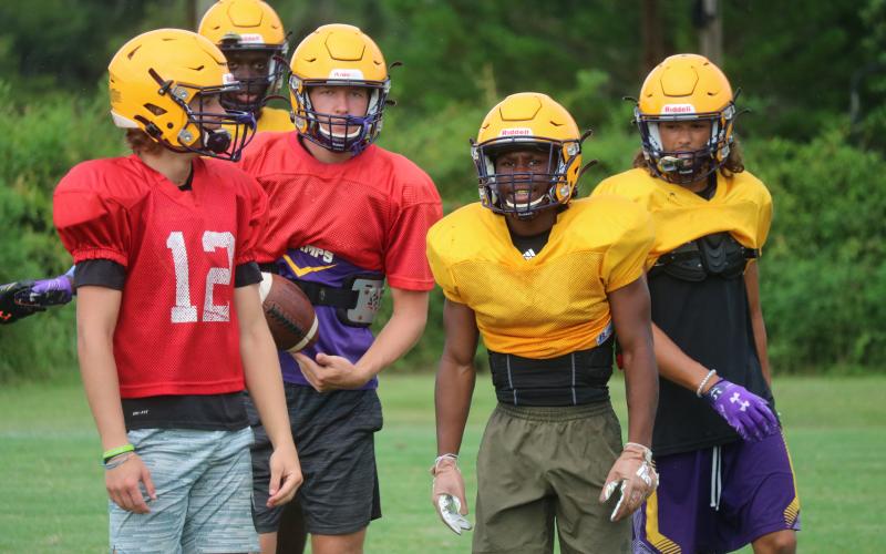 Columbia quarterback Evan Umstead (from left), receiver Brae Deal, quarterback Kade Jackson, running back Leo Robinson and receiver Jace Hoskey react after a play during practice on Aug. 6. (JORDAN KROEGER/Lake City Reporter)