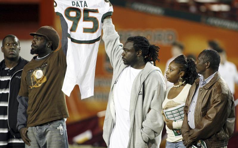 Bryan Pata's family hold up his jersey at the beginning of a game between Miami and Boston College at the Orange Bowl on Nov. 23, 2006, in Miami. Rashaun Jones, 35, of Lake City, a former University of Miami football player was arrested Thursday in connection with the 2006 fatal shooting of his teammate Bryan Pata. Pata, a 22-year-old, 6-foot-4, 280-pound defensive lineman, was shot several times outside of his Kendall apartment the night of Nov. 7, 2006. (AP FILE PHOTO)
