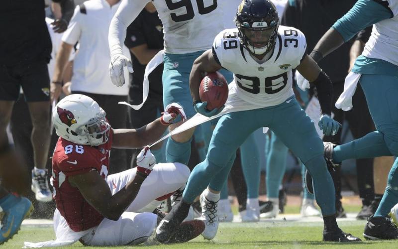 Jacksonville Jaguars wide receiver Jamal Agnew (39) gets away from Arizona Cardinals tight end Demetrius Harris (86) on his way to a 109-yard touchdown run on a missed field goal by the Arizona Cardinals on Sept. 26 in Jacksonville. (PHELAN M. EBENHACK)