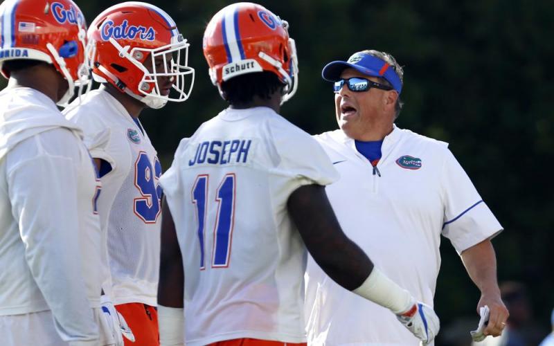 Florida defensive coordinator Todd Grantham works with some of the defense during practice on March 16, 2018, in Gainesville. The 13th-ranked Gators get a chance to show how much they’ve improved. Florida opens the season Saturday night against Florida Atlantic. (BRAD MCCLENNY/Ocala Star-Banner via AP File)