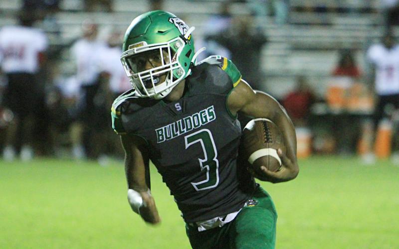 Suwannee running back Malachi Graham runs up the field against Westside on Sept. 3. (PAUL BUCHANAN/Special to the Reporter)