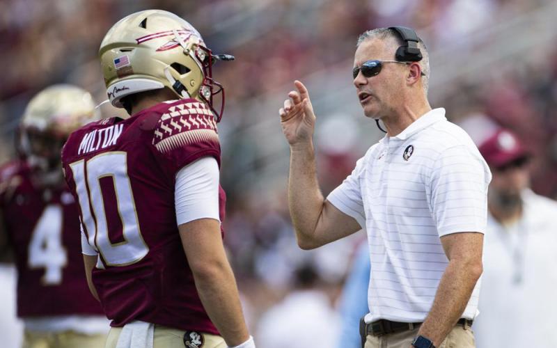Florida State head coach Mike Norvell talks with quarterback McKenzie Milton during a game against Louisville on Sept. 25 in Tallahassee. (MARK WALLHEISER/Associated Press)