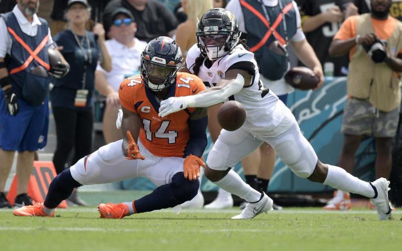 Denver Broncos wide receiver Courtland Sutton (14) catches a pass despite defensive effort by Jacksonville Jaguars cornerback Chris Claybrooks, right, on Sept. 19 in Jacksonville. (PHELAN M. EBENHACK)