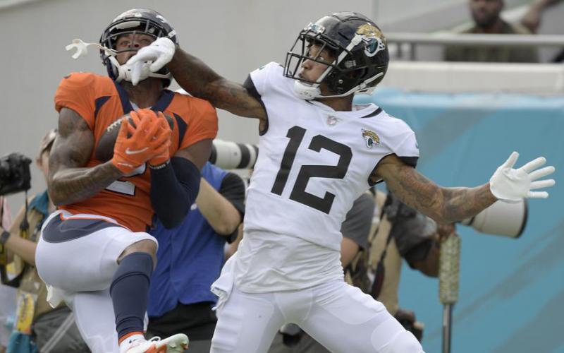 Denver Broncos cornerback Pat Surtain II intercepts a pass intended for Jacksonville Jaguars receiver Tyron Johnson on Sept. 19 in Jacksonville. (PHELAN M. EBENHACK/Associated Press)