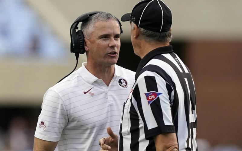 Florida State head coach Mike Norvell speaks with an official during a game against North Carolina on Oct. 9 in Chapel Hill, N.C. (GERRY BROOME/Associated Press)