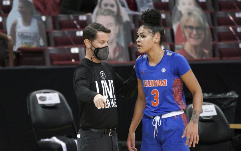 Former Florida head coach Cam Newbauer talks with Lavender Briggs during a game against South Carolina on Dec. 31, 2020, in Columbia, S.C. Briggs said Thursday there are “a bunch of false allegations and narratives going around” regarding what happened during former coach Cam Newbauer’s tumultuous tenure. Several Florida players detailed Newbauer’s abuse, which allegedly included verbal and physical harassment against players, assistants and staff members. (AP FILE)