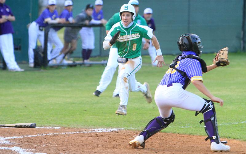 Suwannee’s Tyson Greene beats out a throw at home plate to score a run as Columbia catcher Grant Bowers gets set to catch the ball Tuesday night. (PAUL BUCHANAN/Special to the Reporter)