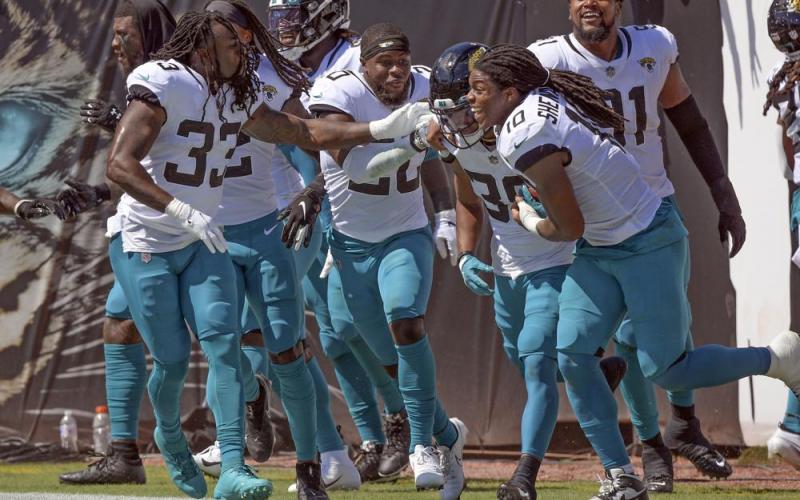 Jacksonville Jaguars players celebrate with wide receiver Jamal Agnew, second from right, after he ran back a missed field goal 109 yards for a touchdown against the Arizona Cardinals on Sept. 26 in Jacksonville. (PHELAN M. EBENHACK/Associated Press)