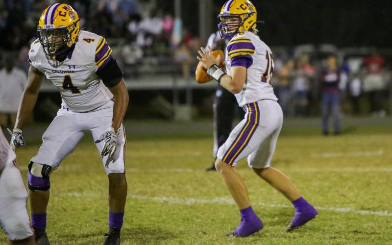Columbia quarterback Evan Umstead (right) drops back to pass against Madison County last Friday. (BRENT KUYKENDALL/Lake City Reporter)