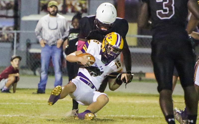Columbia quarterback Evan Umstead is sacked by Madison County on Friday. (BRENT KUYKENDALL/Lake City Reporter)