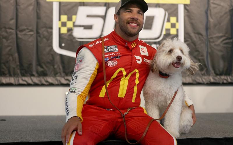Bubba Wallace celebrates in victory lane with his dog Asher after winning the rain-shortened NASCAR Cup Series YellaWood 500 at Talladega Superspeedway on Monday in Talladega, Ala. (CHRIS GRAYTHEN/Getty Images/TNS)