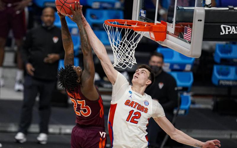 Florida forward Colin Castleton blocks the shot of Virginia Tech guard Tyrece Radford in the first round of the NCAA Tournament at Hinkle Fieldhouse on March 19 in Indianapolis. (AP FILE)