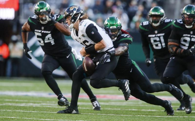 New York Jets linebacker C.J. Mosley strip sacks Jacksonville Jaguars quarterback Trevor Lawrence during Sunday's game in East Rutherford, N.J. (JOHN MUNSON/Associated Press)