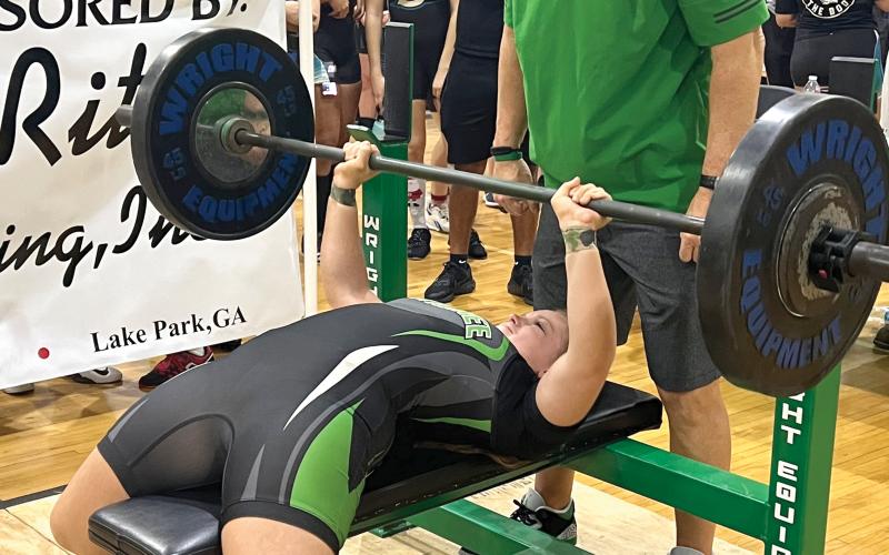 Suwannee’s Emily Gamble bench presses during the Bulldogs’ Power of Christmas invitational. Gamble placed ninth overall in the 169-pound class. (TJ VICKERS/Special to the Reporter)