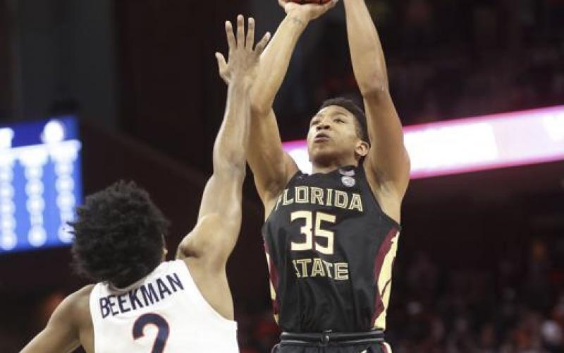 Florida State guard Matthew Cleveland (35) shoots over Virginia guard Reece Beekman (2) during Saturday’s game in Charlottesville, Va. (ANDREW SHURTLEFF/Associated Press)