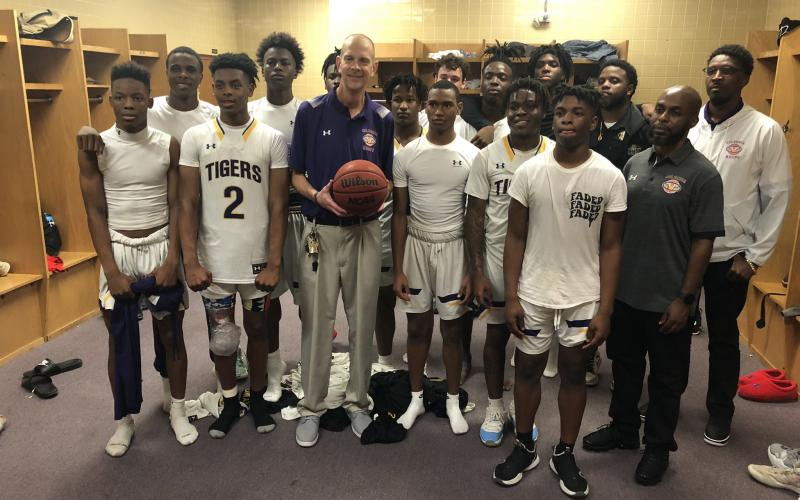 Columbia head coach Steve Faulkner is pictured holding the game ball with his team after the Tigers defeated Forest on Wednesday night. (JORDAN KROEGER/Lake City Reporter)