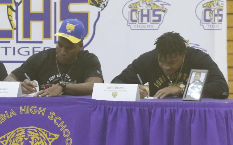 Columbia defensive end Adeon Farmer and running back Jaelin Brown sign their letters of intent Wednesday morning to play at Fort Valley State. (JAMIE WACHTER/Lake City Reporter)