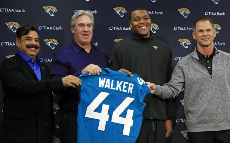 Jacksonville Jaguars owner Shad Khan (from left) head coach Doug Pederson, first-round draft pick Travon Walker, and general manager Trent Baalke hold up Walker’s jersey during a press conference Friday at TIAA Bank Field in Jacksonville. (COREY PERRINE/The Florida Times-Union via AP)