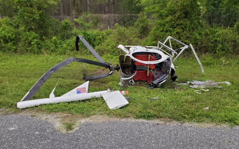 A small helicopter crashed alongside State Road 47 in southern Columbia County on Saturday. The two occupants suffered minor injuries. (COURTESY)