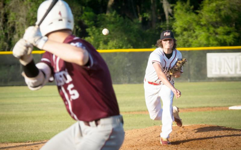 Fort White pitcher Jonathan Fischer throws a pitch to Madison County’s JD Bryan during Tuesday’s game. (CHRISTINA FEAGIN/Special to the Reporter)