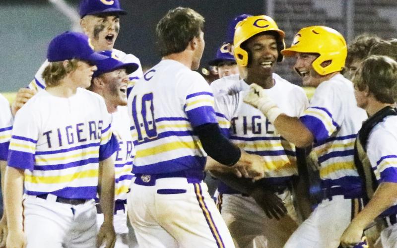 Columbia first baseman Ty Floyd (right) celebrates with teammates after hitting a walk-off single against Riverview in the District 3-5A semifinals on Tuesday. (JORDAN KROEGER/Lake City Reporter)