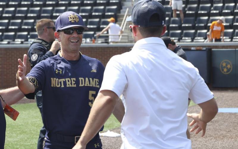 Notre Dame head coach Link Jarrett (left) celebrates after the team defeated Tennessee in an NCAA super regional game on June 12 in Knoxville, Tenn. (RANDY SARTIN/Associated Press)