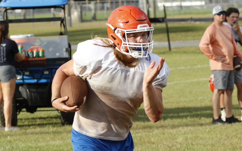 Branford running back Caden Coker carries the ball up the field during practice on Aug. 5. (JAMIE WACHTER/Lake City Reporter)