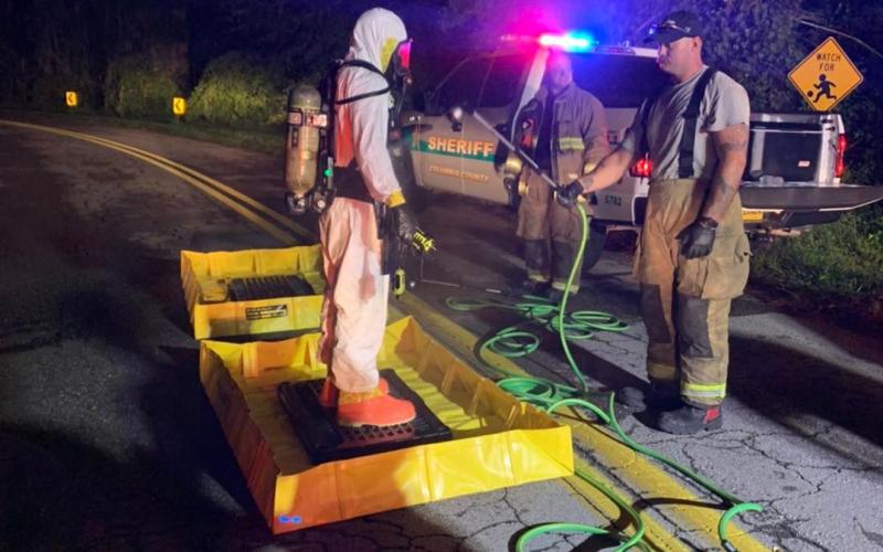 A first responder in a hazmat suit gets decontaminated after a traffic stop Wednesday night. (COURTESY LCFD)