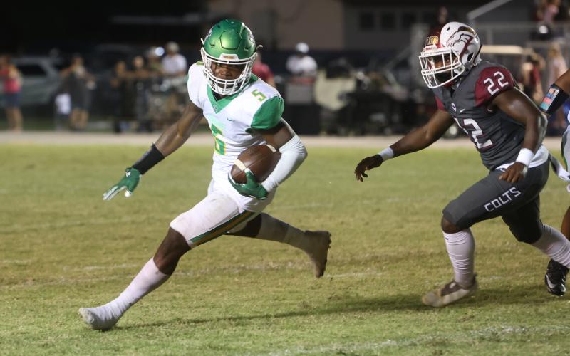 Suwannee running back Brandon Robinson takes a carry up the field against North Marion on Friday. (PAUL BUCHANAN/Special to the Reporter)