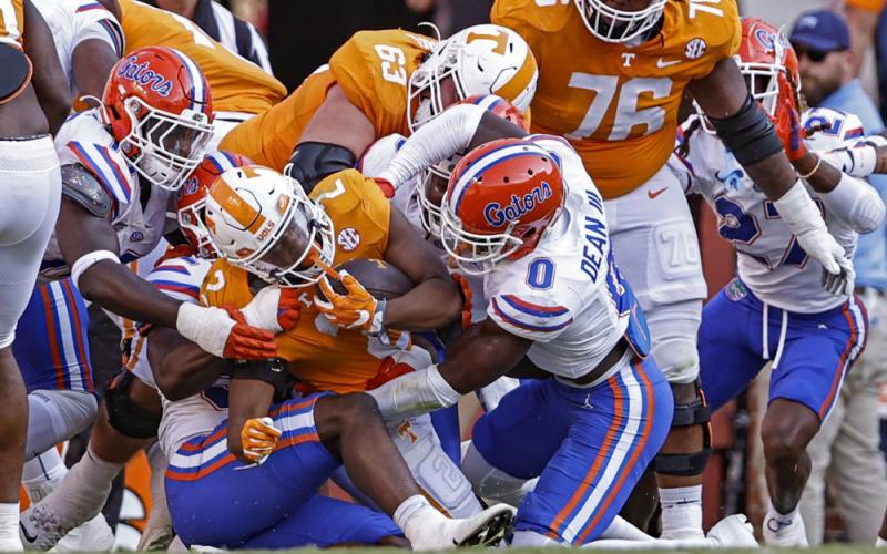 Tennessee running back Jabari Small (2) is stopped at the goal line by Florida safety Trey Dean III (0) and others during Saturday’s game in Knoxville, Tenn. (WADE PAYNE/Associated Press)