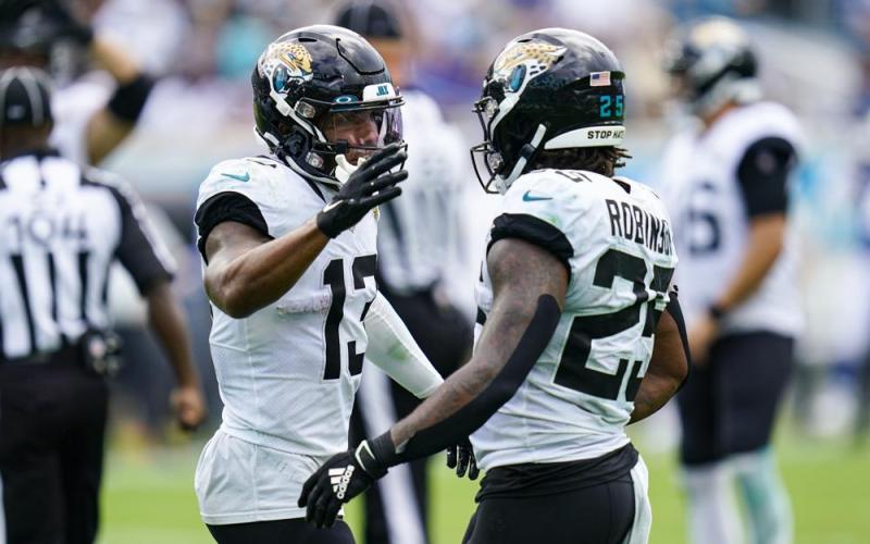 Jacksonville Jaguars wide receiver Christian Kirk (13) celebrates his touchdown with running back James Robinson (25) against the Indianapolis Colts during Sunday’s game Jacksonville. (JOHN RAOUX/Associated Press)