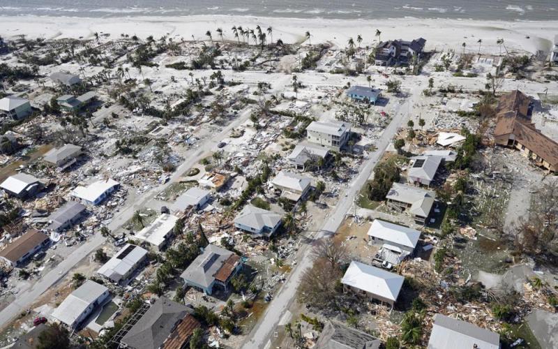 This aerial photo shows damaged homes and debris in the aftermath of Hurricane Ian on Thursday in Fort Myers. (WILFREDO LEE/Associated Press)