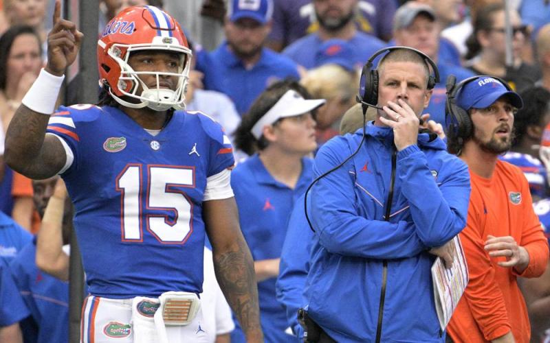 Florida coach Billy Napier (right) and quarterback Anthony Richardson (15) watch from the sideline during Saturday's game against Utah in Gainesville. (PHELAN M EBENHACK/Associated Press)