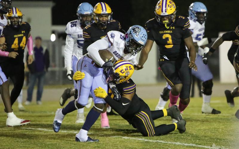 Columbia safety Amare Ferrell wraps up Gadsden County running back Cedric Byrd on Friday night. (BRENT KUYKENDALL/Lake City Reporter)