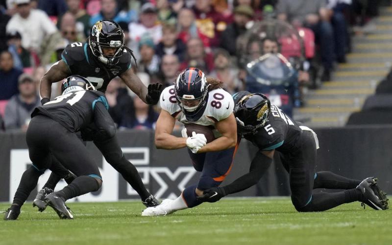 Denver Broncos tight end Greg Dulcich dives for yardage during Sunday's game against the Jacksonville Jaguars at Wembley Stadium in London. (KIRSTY WIGGLESWORTH/Associated Press)
