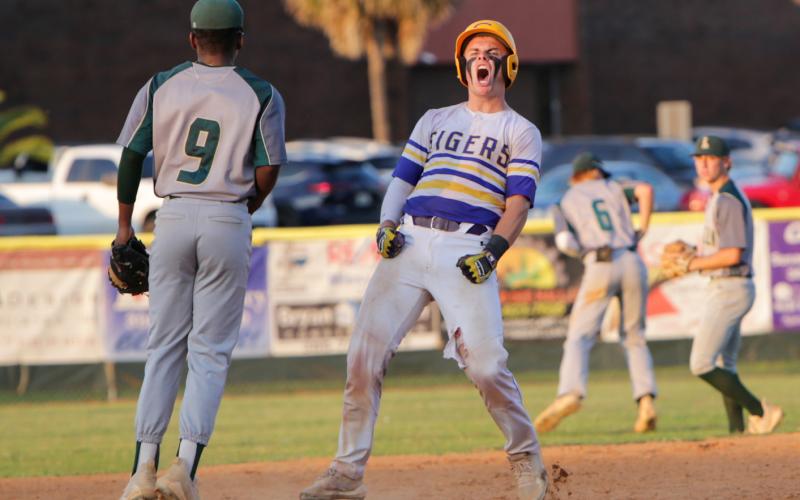 Columbia’s Hayden Gustavson celebrates after reaching second base against Lincoln in last season’s regional final. (BRENT KUYKENDALL/Lake City Reporter)