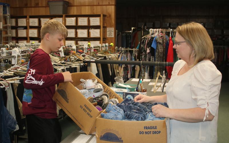 Shannon Hardin (right) sorts through clothing items at the Christian Service Center. Hardin has helped provide clothing for the underprivileged through her Clothes 4 Kids Closet project. (JAMIE WACHTER/Lake City Reporter)