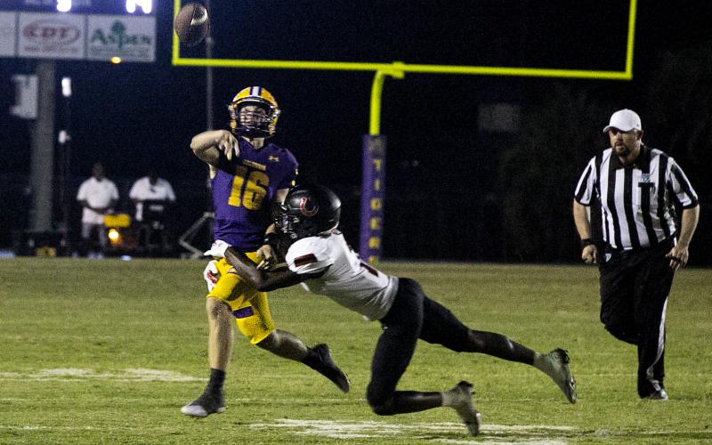 Columbia quarterback Evan Umstead throws a pass out of defensive pressure against Middleburg on Friday. (JEN CHASTEEN/Special to the Reporter)