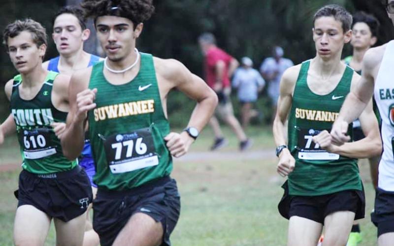 Suwannee’s Morgan Mobley races up the course with teammate Paul Gunter (right) at the Region 1-2A meet on Friday. (COURTESY)