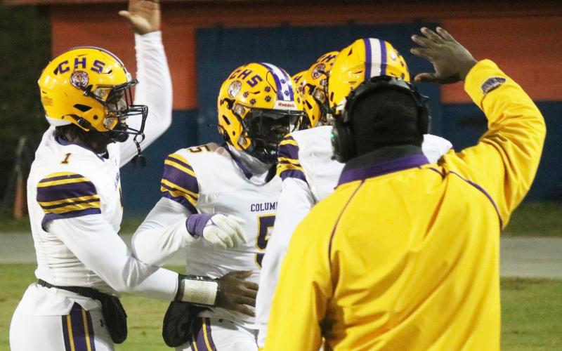 Columbia linebacker Jaden Robinson (5) celebrates with quarterback Tyler Jefferson (1) and others after scoring on a pick-6 against Escambia in the Region 1-3S semifinals on Friday. (JORDAN KROEGER/Lake City Reporter)