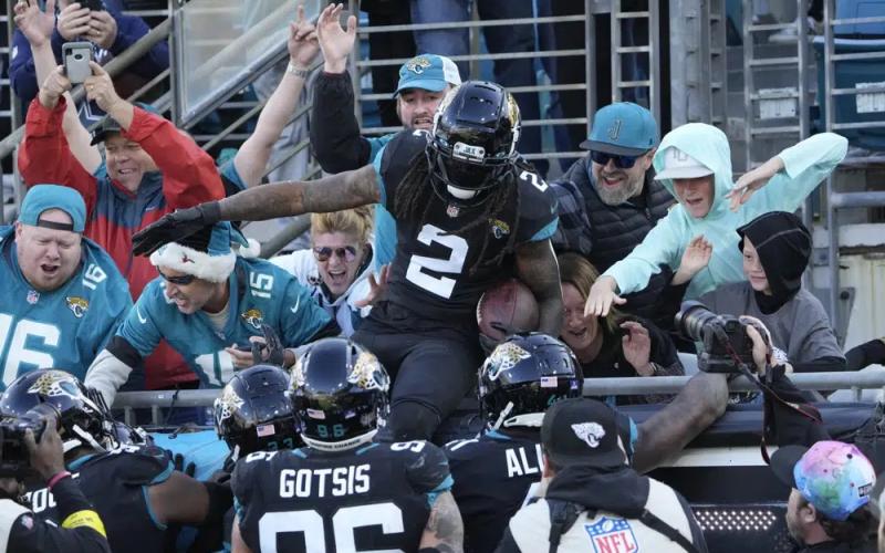 Jacksonville Jaguars safety Rayshawn Jenkins (2) celebrates with fans after his interception return for a touchdown against the Dallas Cowboys on Sunday in Jacksonville. (JOHN RAOUX/Associated Press)