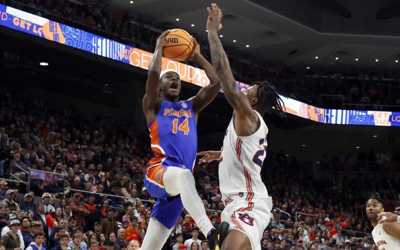 Florida guard Kowacie Reeves goes up for a shot as Auburn guard Allen Flanigan defends on Wednesday in Auburn, Ala. (BUTCH DILL/Associated Press)