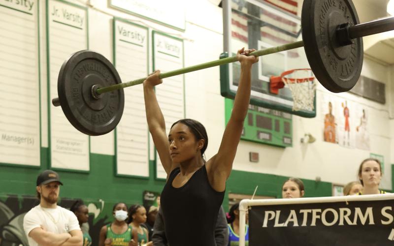 Columbia’s Sakiya Merriex completes her clean and jerk during the District 3-2A meet on Friday. (PAUL BUCHANAN/Special to the Reporter)