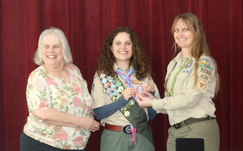 Skylar Beichner center is presented with her Eagle Scout rank patch by her grandmother Ruth Kennedy (left) and mother Lodisca Beichner during a ceremony on Saturday. (TONY BRITT/Lake City Reporter)