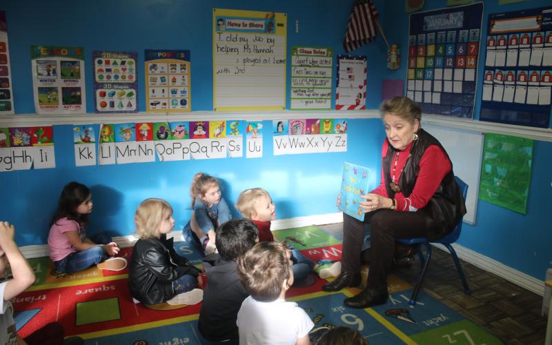 Ann Bormalini (right) reads ‘10 Little Fish’ to pre-kindergarten students at the My Little Red Schoolhouse Daycare on Friday morning. Rotarians visited several local public schools and private early childhood centers Friday as part of Rotary Readers. (TONY BRITT/Lake City Reporter)