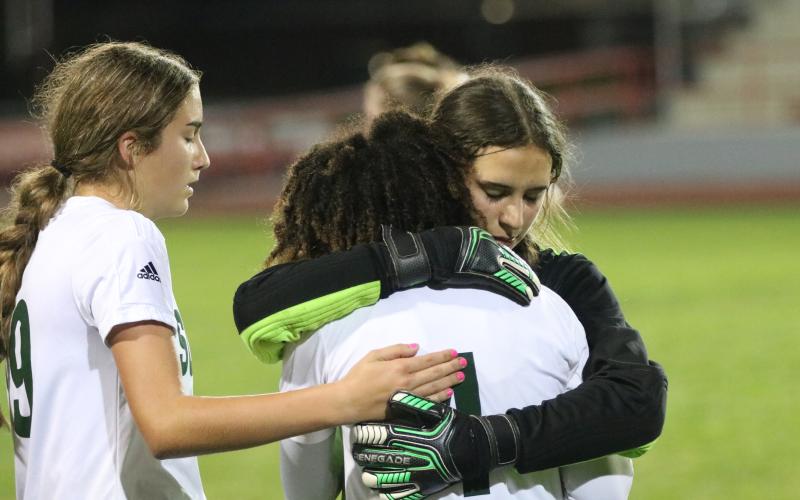 Suwannee goalkeeper Layla Merola hugs and consoles Alaira Handy following the Bulldogs’ 2-1 loss to Santa Fe in the District 2-4A championship on Monday night. (JORDAN KROEGER/Lake City Reporter)