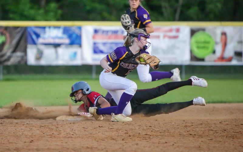 Middleburg's Mika Wesley slides safely into second base before Columbia shortstop Anna Dansby can apply a tag on Friday night. (BRENT KUYKENDALL/Lake City Reporter)