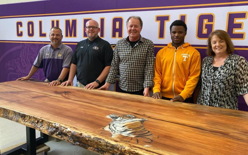 Trey Hosford (from left) Columbia High School principal, stands with Doug Peeler, Scott Stewart, Tray Tolliver and Jill Hunter, after Stewart donated a table he made to the school on Thursday afternoon. (COURTESY)