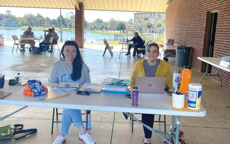 Volunteers sit at a makeshift desk at Wilson Park during a Florida drivers license restoration event in 2022. (COURTESY)