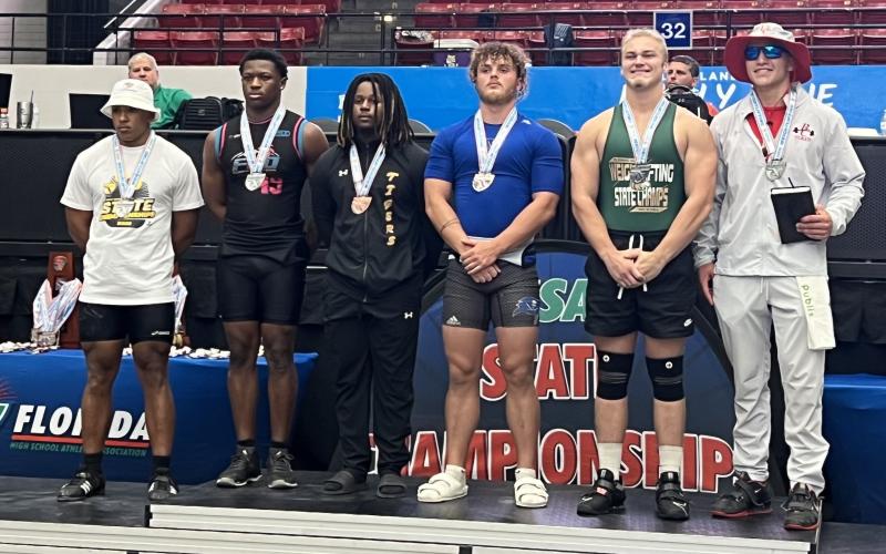 Columbia's Tony Fulton (third from left) placed third in the 199 class in traditional at the Class 2A state meet on Saturday. (COURTESY)